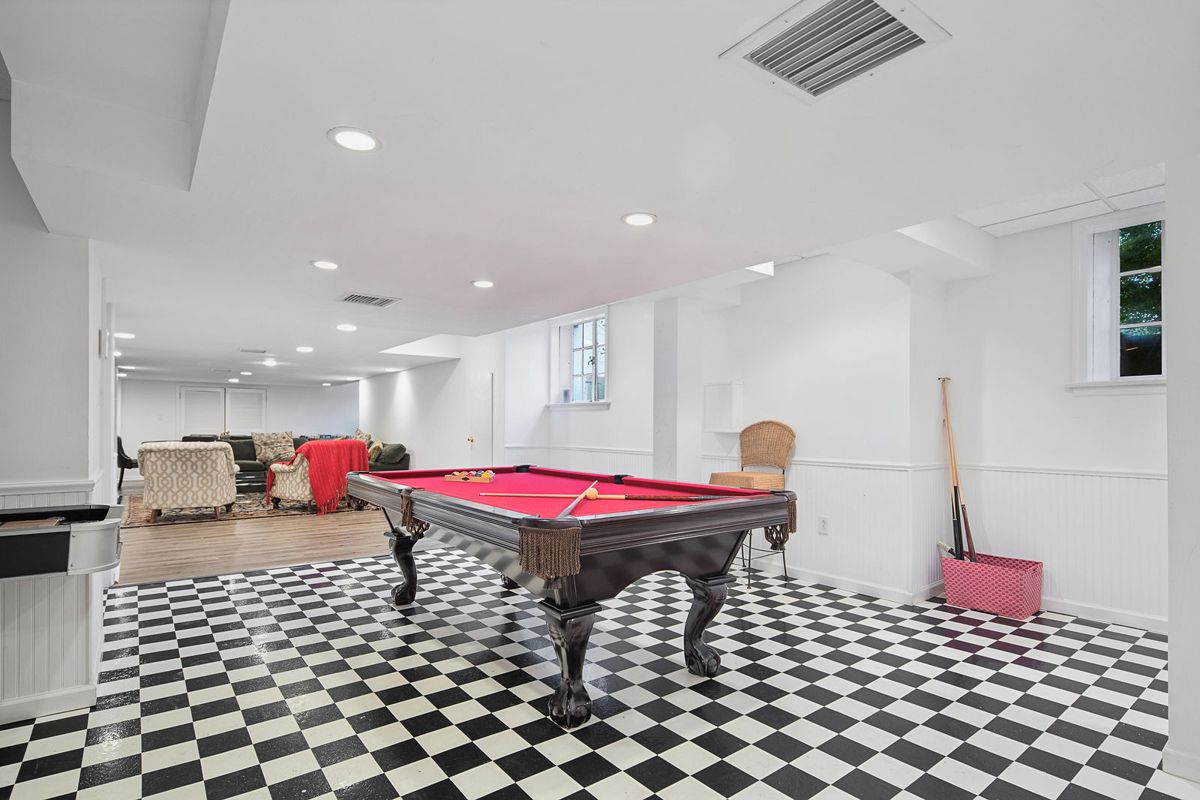 Lower level billiard room with checkerboard floor at 184 Upper Mountain Avenue