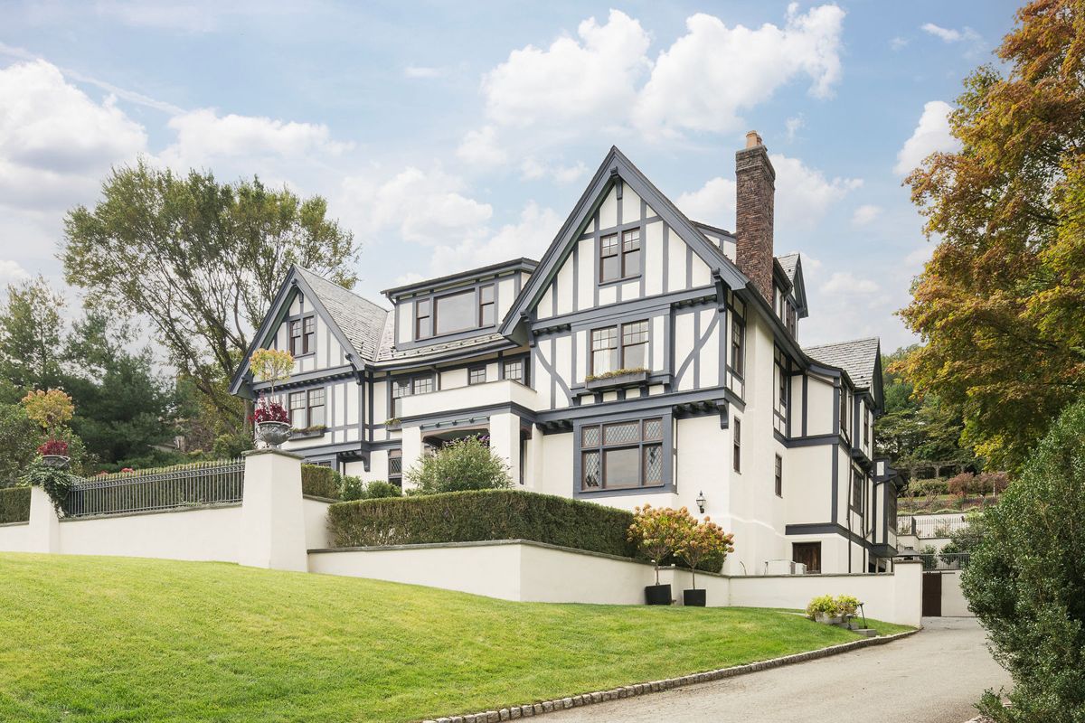 Broad front lawn rising to the Tudor facade of 184 Upper Mountain Avenue