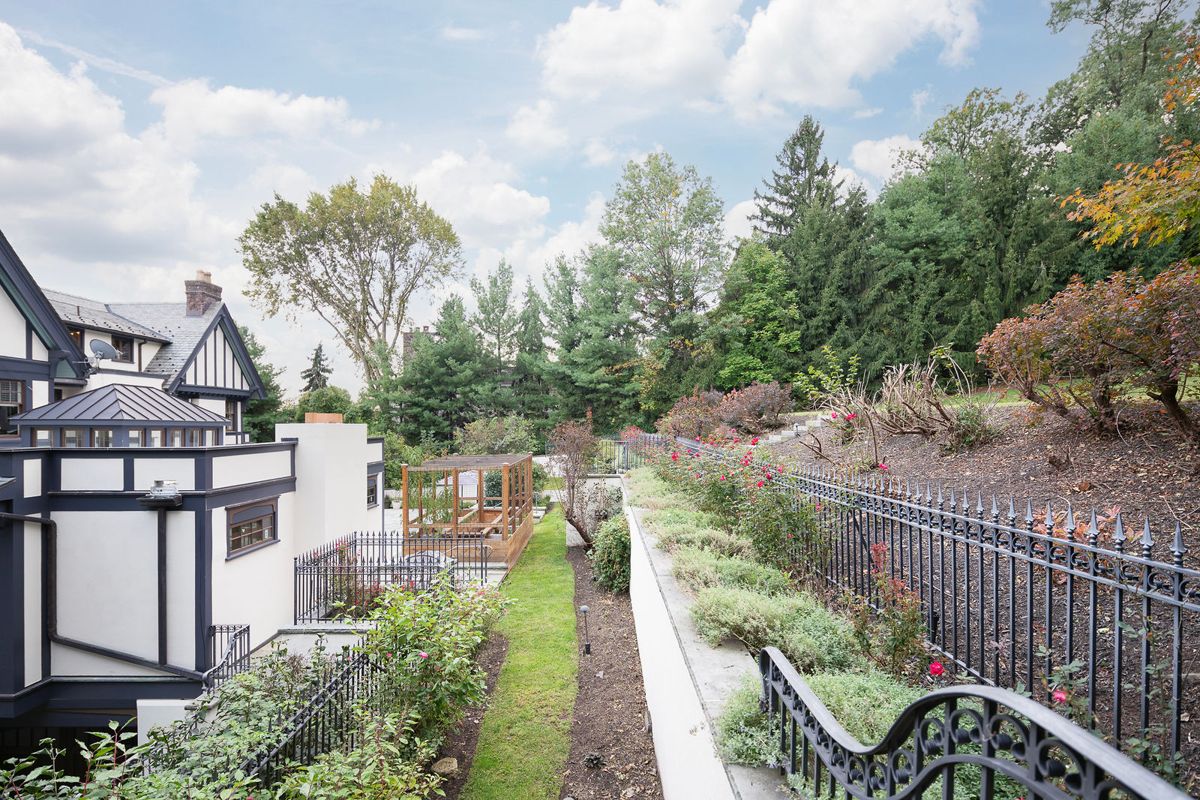 Garden walk along wrought iron fencing at 184 Upper Mountain Avenue