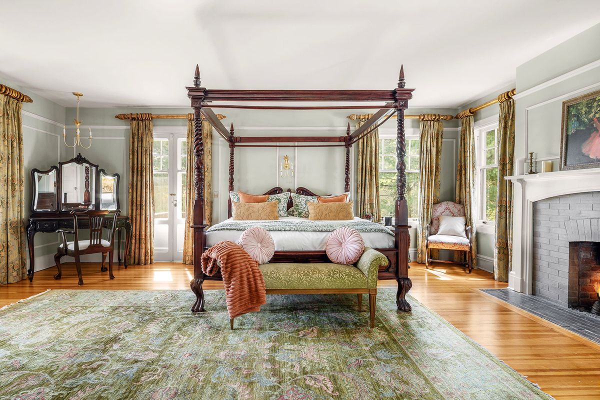 Primary bedroom with four poster bed and fireplace at 184 Upper Mountain Avenue