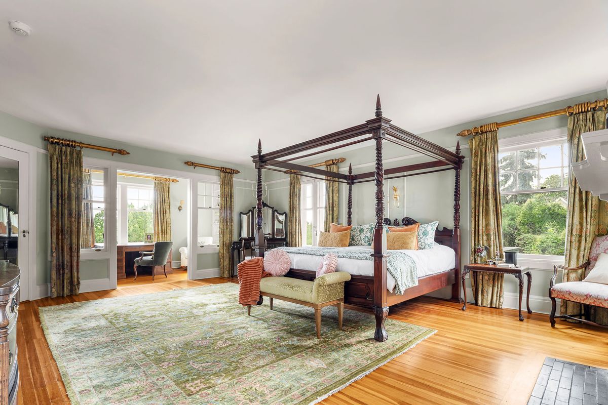 Primary bedroom with fireplace and garden views at 184 Upper Mountain Avenue