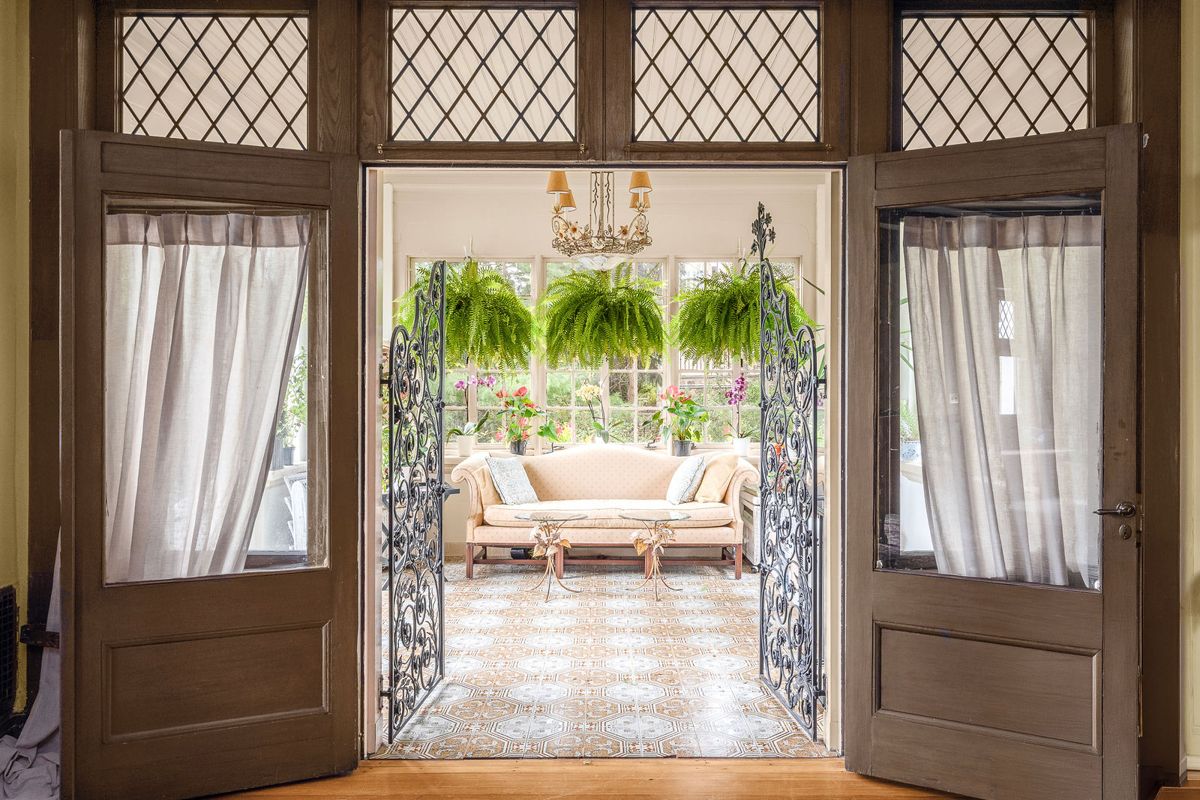 Wrought iron doors opening from the living room into the solarium at 184 Upper Mountain Avenue